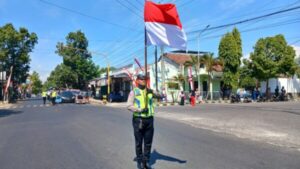 Satlantas Bondowoso Hentikan Pengguna Jalan Untuk Memberikan Penghormatan Kepada Bendera Merah Putih